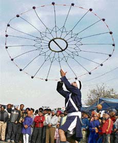 A Sikh in a traditional dress shows his martial arts skills during the Parkash Utsav procession in Jammu