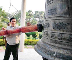 U Nyan Win, foreign minister of Myanmar, rings the holy peace bell of Mahabodhi Temple during his visit to Bodhgaya on Thursday.