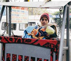 Praveen Kaur, mother of two girls, places her third child in a cradle outside the district Red Cross Bhawan under the Cradle Scheme. 