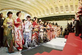Tokyo Stock Exchange workers, dressed in Kimono join the ceremonial handclapping to start the first trading after the new year holidays during ceremony at the TSE in Tokyo on Friday