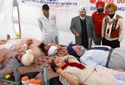 Volunteers donating blood at the camp organised at PU gurdwara on the eve of gurpurb