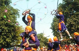 Sikh devotees perform the traditional martial art Gatka during a procession in the Capital on Friday.