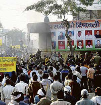 Activists of the Dalit A-Block Mahapanchayat, Haryana, torch a hoarding at Congress Bhawan in Rohtak on Friday.