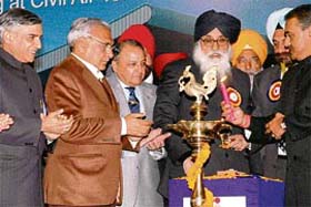 Punjab Chief Minister Parkash Singh Badal lights the lamp at the foundation stone-laying ceremony of the extension of the Chandigarh Airport terminal