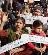Doda migrants protest outside the office of the Divisional Commissioner demanding relief benefits in Jammu on Friday.
