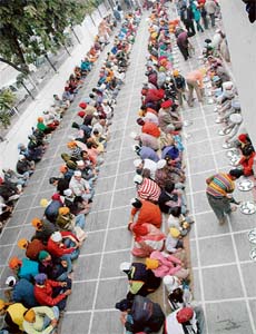 Devotees partake of langar on Gurpurb at Gurudwara Patshahi 10th in Sector 8, Chandigarh