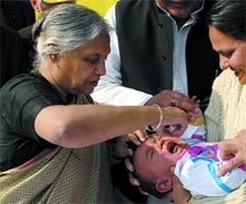 Delhi Chief Minister Sheila Dikshit administers pulse polio drops to a child at her residence in the Capital on Saturday. 