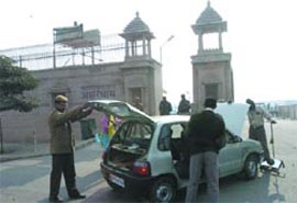 Security personnel check a car outside the Akshardham Temple in the Capital on Saturday. Security has been beefed up at the temple following a threat to blow it up.