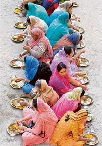 Sikhs partake langar at a common kitchen in a gurdwara on the birth anniversary of Guru Gobind Singh in Siliguri on Saturday.