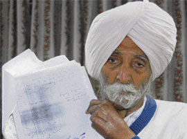 Mehma Singh shows reports that declared him innocent, which he procured through the RTI Act, in Chandigarh on Sunday.