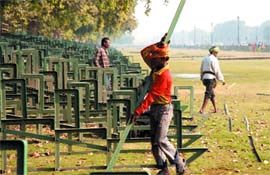 Workers prepare for the Republic Day Parade at the India Gate in the Capital on Sunday.
