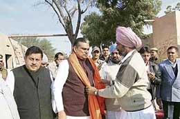 Parliamentary secretary Dura Ram being felicitated by villagers in Fatehabad on Sunday.