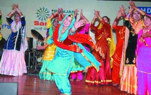 Girls put up a dance performance during the NRI Sammelan in Jalandhar on Sunday. 