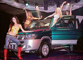 Models pose in front of International Cars and Motors Limiteds new 'Rhino RX' at its launch in New Delhi on Monday. It is priced at Rs 600,000. 