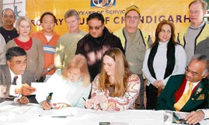 Members of the Rotary Club of Coral Gables, Florida, sign an agreement with their counterparts in Chandigarh on Monday.