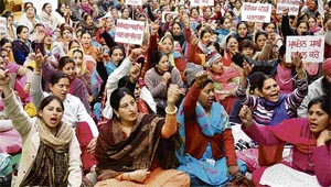 Disgruntled teachers raise slogans outside the office of DPI (elementary) Harcharanjit Kaur Brar in Sector 17, Chandigarh, on Monday.