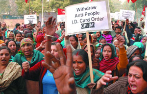 CPI(M) activists shout slogans during a demonstration against the proposed order on carrying identity cards near the Parliament House in the Capital on Monday.