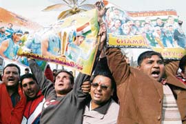 Cricket supporters wave posters featuring photos of Indian cricketers in Amritsar on Monday in protest against bad umpiring during the second Test between India and Australia and the three-match ban on Harbhajan Singh. 