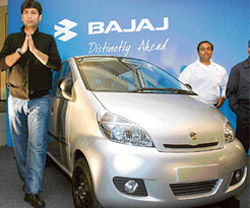 Managing director, Bajaj Auto, Rajiv Bajaj poses with the new unveiled Lite, four-wheeler passenger vehicle, in New Delhi