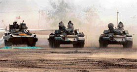 T-72 tanks of the Indian Army perform a mock combat drill on the first day of a three-day long Know Your Army exhibition, at Rajkot, about 220 km west of Ahmedabad on Tuesday.