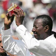 West Indies umpire Steve Bucknor shows a memento to mark the umpiring of his 100th Test