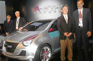 Managing director of Maruti Suzuki India S. Nakanishi (2nd from left) and other officials pose with the newly unveiled A-Star concept car at the 9th Auto Expo.
