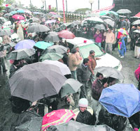 Despite bad weather BJP supporters throng Raj Bhawan for the swearing-in ceremony.