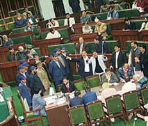 Panthers Party and BJP legislators protest near the well in the lower house in Jammu on Wednesday.