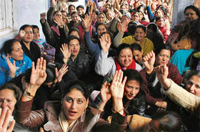 Members of the Jammu and Kashmir Teachers Forum protesting outside the office of the divisional commissioner, in Jammu on Wednesday.