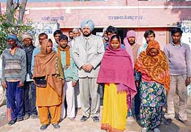 The bonded labourers coming out of the police station after being freed from a cotton factory in Bathinda on Thursday along with Jagjit Singh Joga (centre), district general secretary of the CPI, who got them freed.