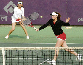 Players in action during a match of the ITF Tennis Tournament being played in Chandigarh on Friday.