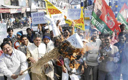 Samajwadi Party activists burn an effigy of UP Chief Minister Mayawati during their demonstration against the UP government at Committee Chowk in Karnal