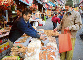 A man buying Lohri eatables in Lower Bazar, Shimla. 