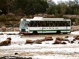 An HRTC bus negotiates the flooded Chakki rivulet connecting Punjab and Himachal in Nurpur subdivision. Following the washing away of the inter-state Chakki bridge in August last year, the vehicular traffic on the Pathankot-Mandi national highway was diverted from the Kandwal- Bhadroya state highway but buses keep entering the flooded rivulet, risking the lives of passengers.