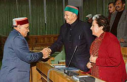 Chief Minister Prem Kumar Dhumal exchanges greetings with former Chief Minister Virbhadra Singh and CLP leader Vidya Stokes on the first day of the winter session of the Vidhan Sabha at Dharamsala on Friday.