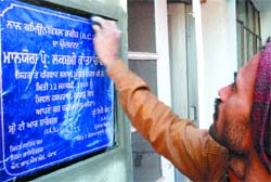 A worker gives final touches to the inauguration stone of pilot project on NCDs.