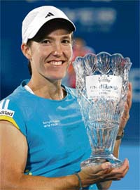 Justine Henin holds the trophy after beating Svetlana Kuznetsova in the final of the Sydney International tennis tournament