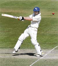 ACT XIs John Rogers plays a shot during the warm-up match against India