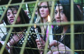 Indian- American fashion designer Anand John's sister and mother join models in a candlelight protest against his arrest at Jantar Mantar in the Capital on Saturday. John has been charged with rape of models in US.
