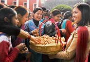 Students of Government College for Women distribute peanuts and gachak to celebrate Lohri.