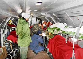 A medical team attends to a casualty in a specially modified AN-32 during evacuation of the injured ITBP personnel.