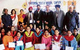 Trainees of sewing school at Manakwal village with their respective certificates.