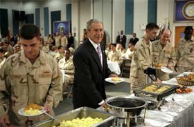 US President George W Bush joins the chow line as he dines with US military personnel on a naval base in Bahrain
