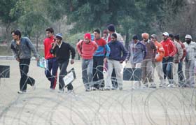Youths lining up for the tokens at the Government Rajindra College in Bathinda on Monday. 
