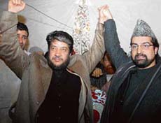 All-Party Hurriyat Conference chairman, holding the hand of another senior separatist leader and president of the Democratic Freedom Party, Shabir Ahmad Shah, at Eidgah in Srinagar on Monday. 