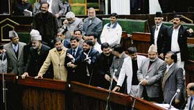 Opposition members during a loud protest in the Jammu and Kashmir assembly to demand a discussion on corruption charges against a minister, on Monday. 