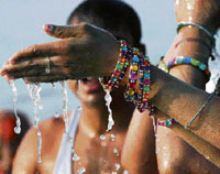 Hindu pilgrims perform rituals as they worship Sun God during an early morning dip at Gangasagar, some 150 km south of Kolkata, on Monday.
