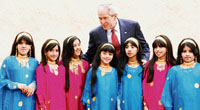 U.S. President George W. Bush greets children who danced for him during his visit to the Sheikh Saeed Al Maktoum House in Dubai on Monday.