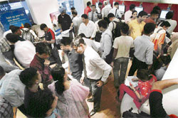 Investors crowd a Reliance counter to submit subscription forms for buying the Initial Public Offering of Reliance Power in Mumbai