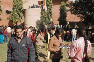 Students wait for hours before the rehearsal of the convocation in Chandigarh on Tuesday.
